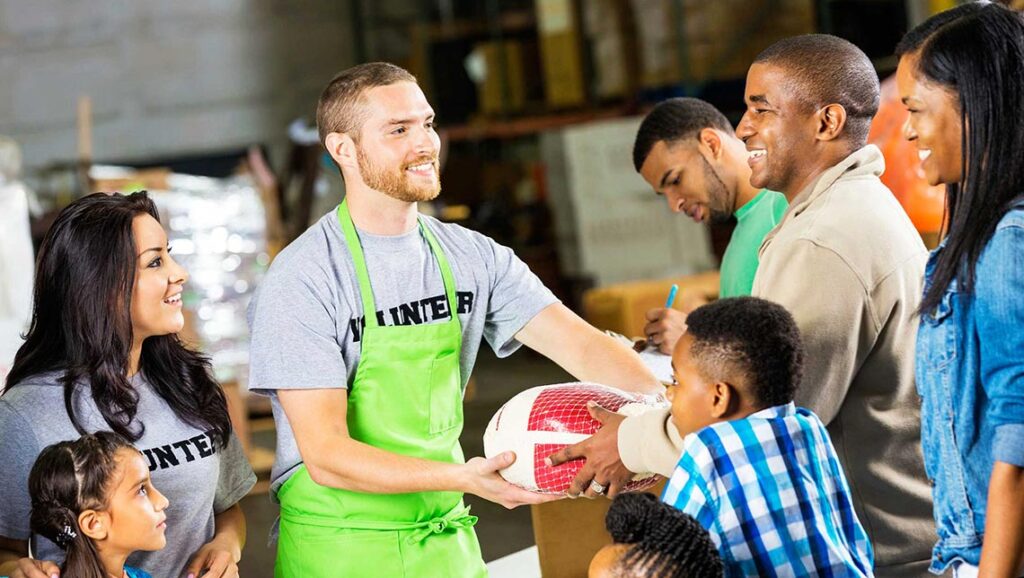 Distributing gift hampers to the needy